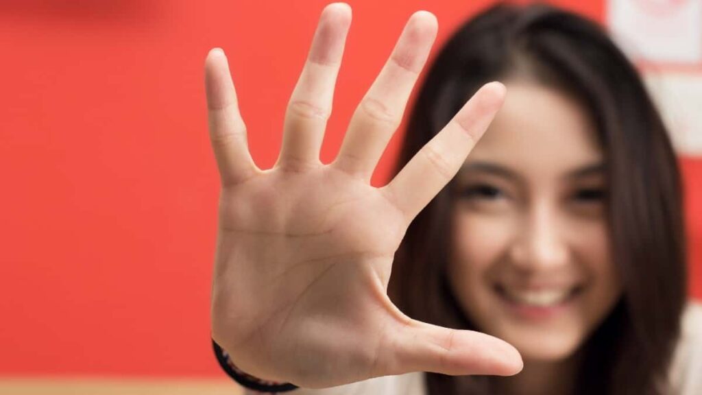 I asked ChatGPT for its top 5 FTSE 100 stocks to buy for March 2026 Young female hand showing five fingers.