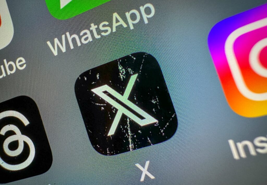 X says it’s reducing payments to clickbait accounts X icon on a smartphone screen