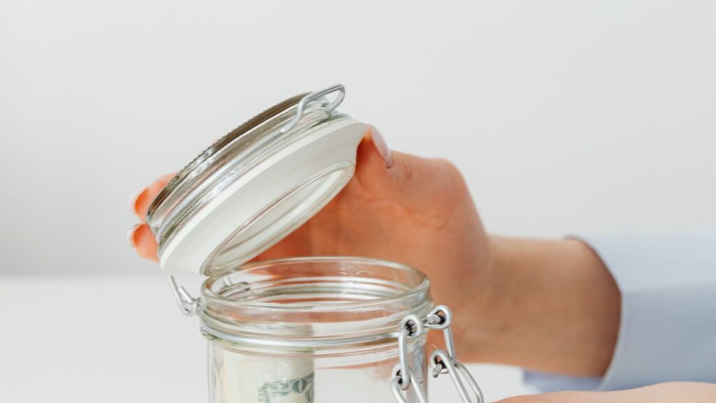 Coins in a jar representing an emergency fund