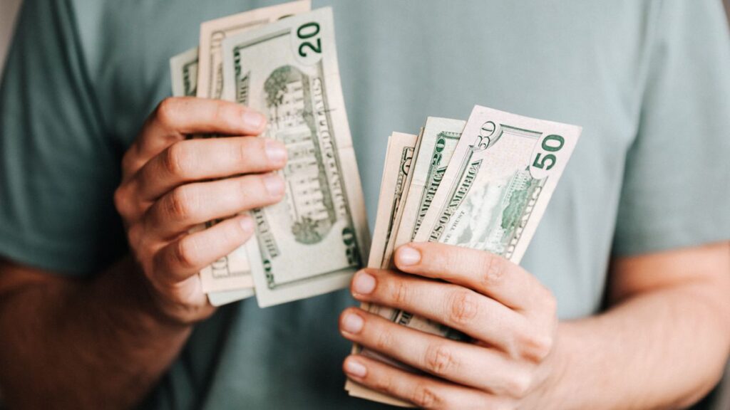 Person sending money on a phone, illustrating UAE Pakistan remittances growth