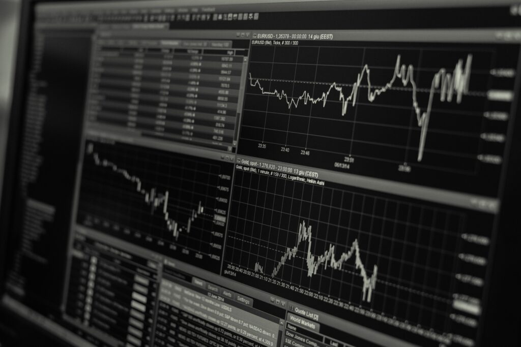 A financial analyst reviewing charts that show the growth of the AI stock market bubble.
