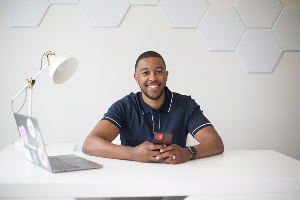 Why It is Easier to Achieve FIRE at 35 Than 50 A young professional working on a laptop, planning how to achieve FIRE at 35.