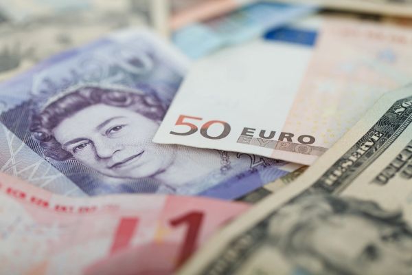 How the Fed Policy Outlook Impacts Global Currencies Like the Yen A financial analyst reviewing charts showing how the fed policy outlook impacts global exchange rates