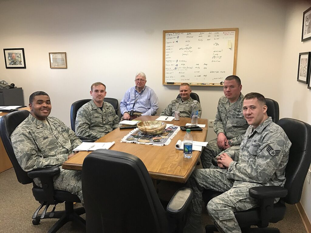A professional working as an entrepreneurship center director meeting with local business owners